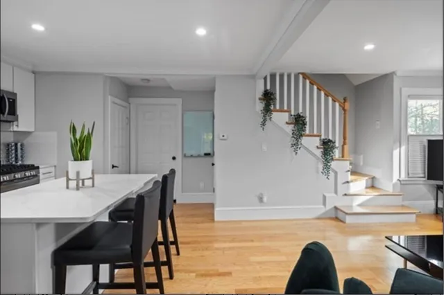 a living room with dining room and couches