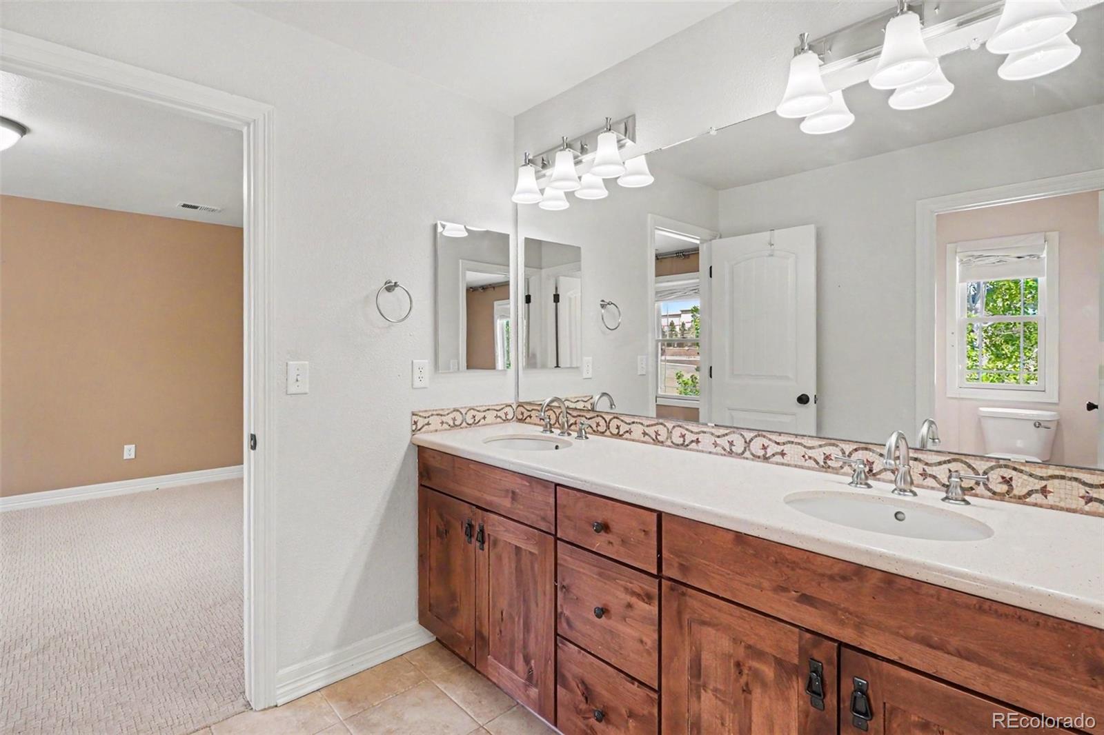 791 Elk Rest Road Evergreen, CO 80439 - Photo 26 of 46 a bathroom with a sink double vanity and a mirror