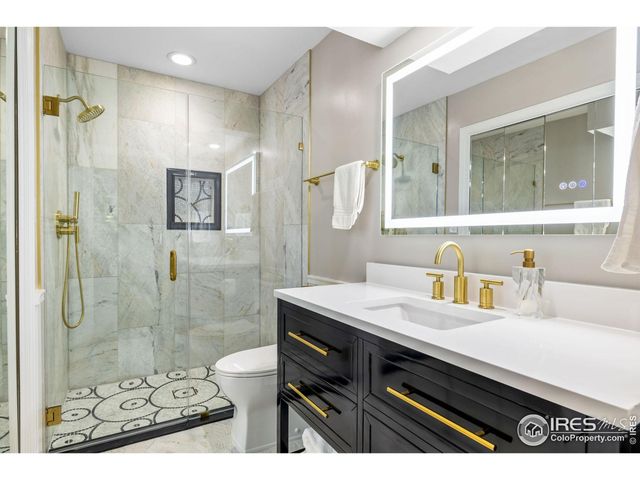 a bathroom with a sink shower and a mirror