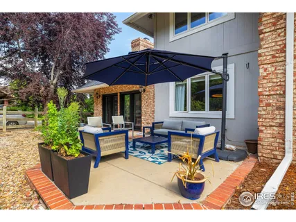 a view of road with card parked on side and retail shops