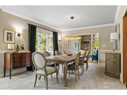 a view of a dining room with furniture and windows