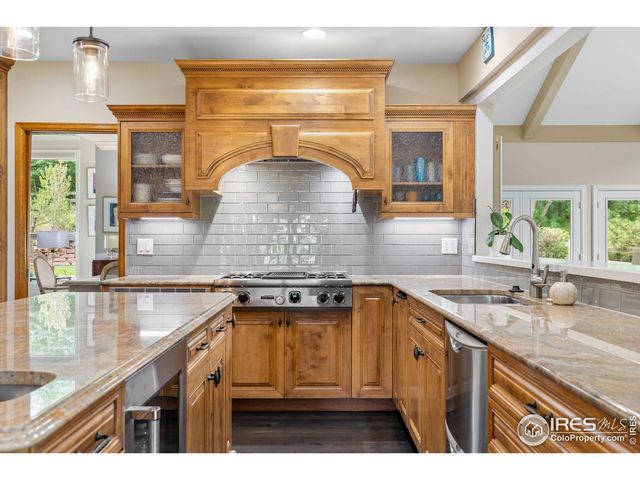 a kitchen with a sink a counter top space and cabinets