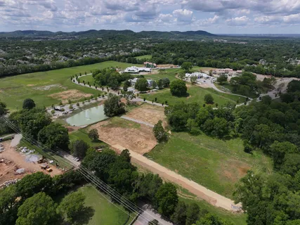 an aerial view of residential houses with outdoor space and river