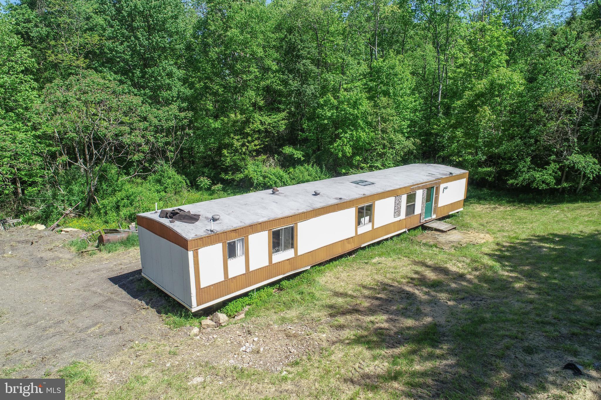 1011 Teets Road Friendsville, MD 21531 - Photo 2 of 19 a view of a house with large trees and a yard