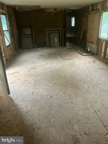 a view of an empty room and fire place