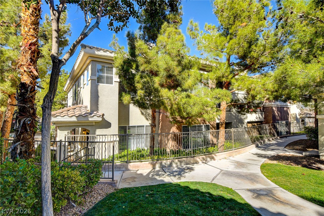 9050 West Warm Springs Road, Unit 1034 Las Vegas, NV 89148 - Photo 2 of 17 A terracotta roof and stucco facade welcome you to this charming residence, surrounded by lush trees and manicured grounds.
