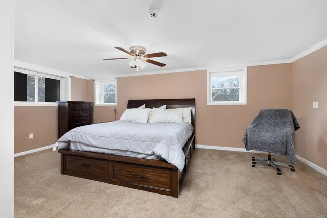 a spacious bedroom with a bed and a chandelier