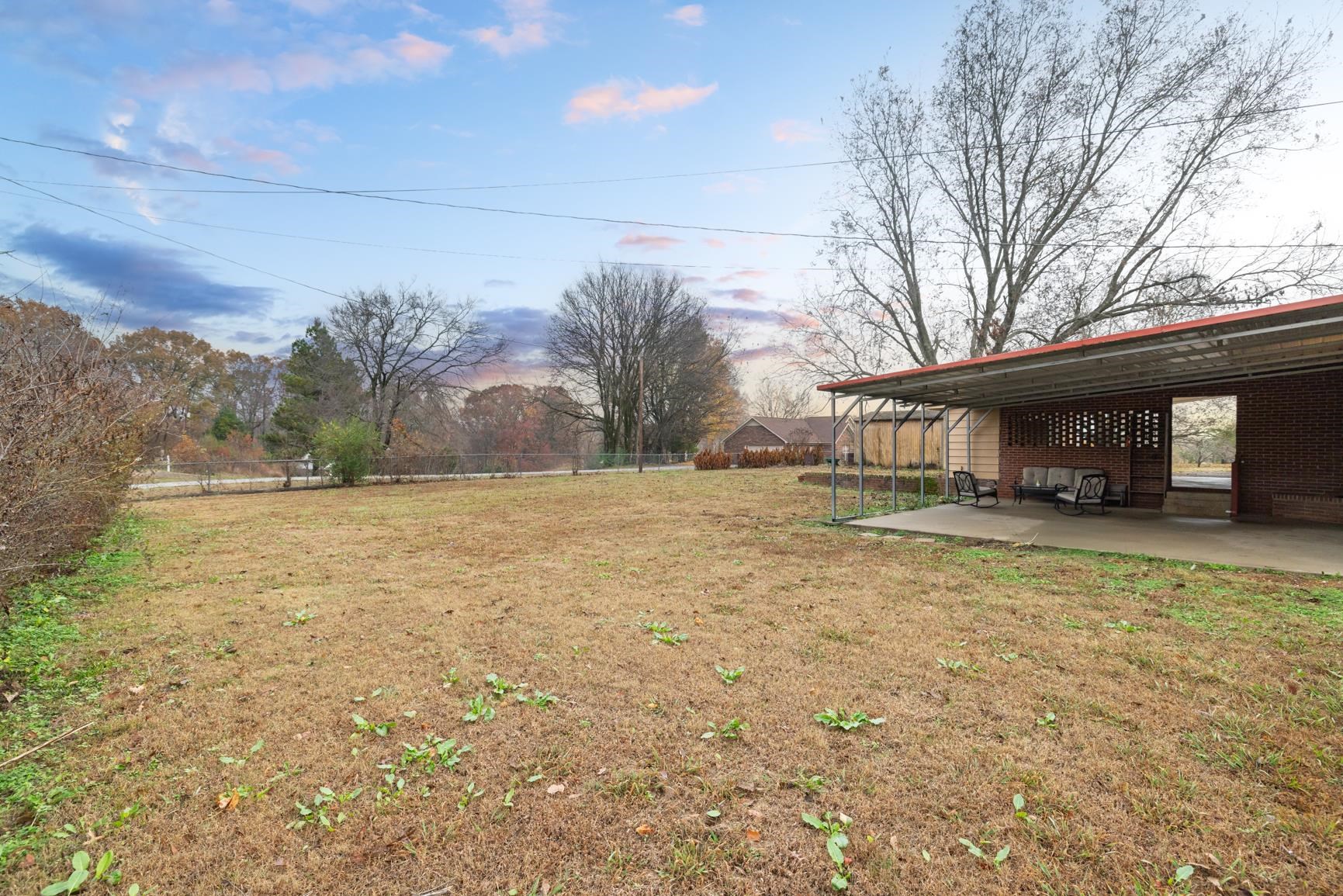 5466 Highway 59 Covington, TN 38019 - Photo 25 of 36 a front view of house with yard and trees in the background