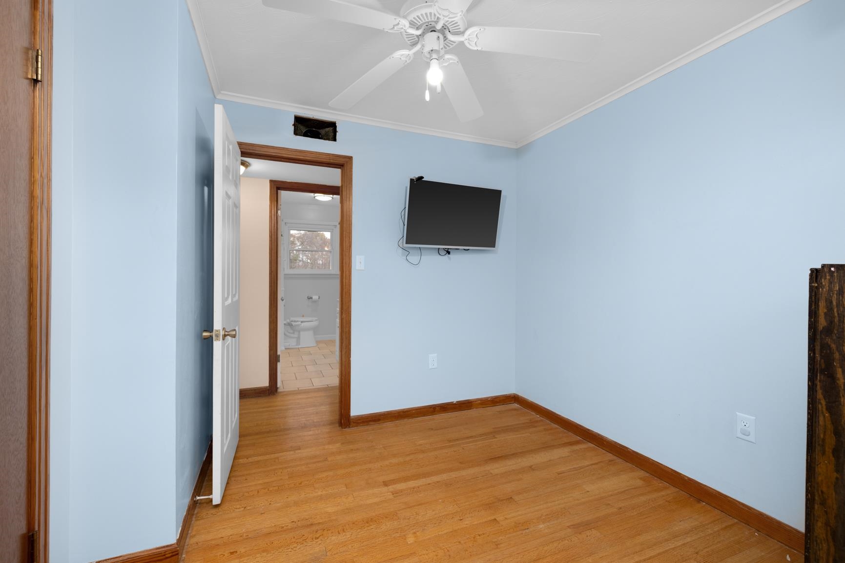 5466 Highway 59 Covington, TN 38019 - Photo 30 of 36 Unfurnished bedroom with light wood-style floors, ornamental molding, and a ceiling fan
