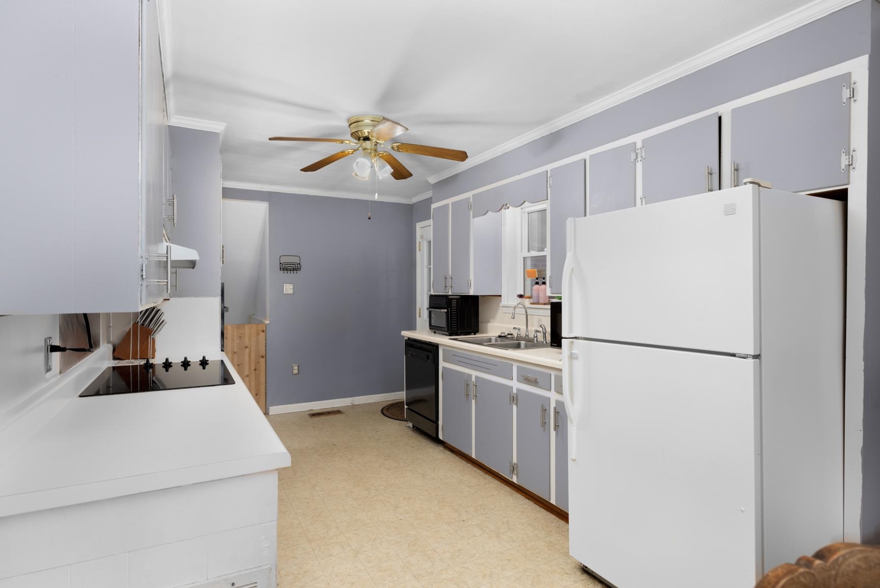 5466 Highway 59 Covington, TN 38019 - Photo 33 of 36 a kitchen with stainless steel appliances a refrigerator sink and white cabinets