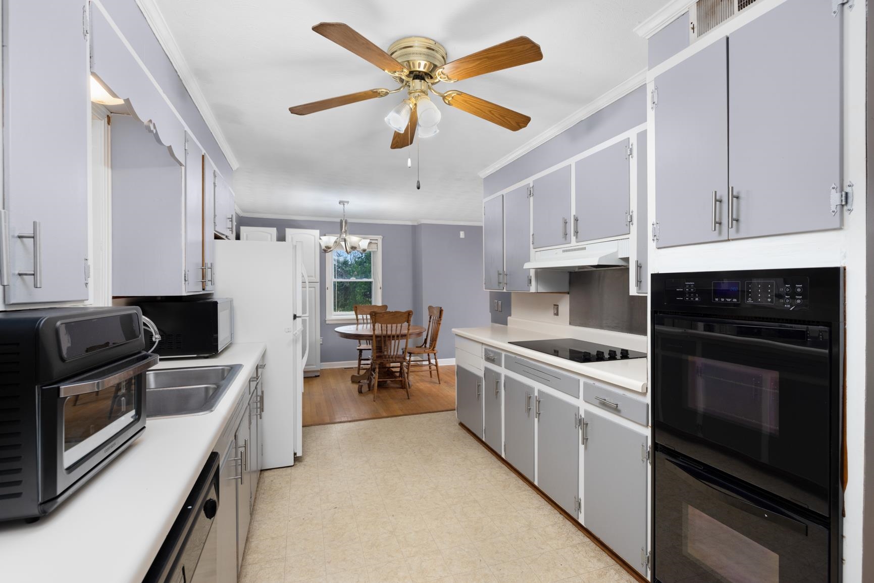 5466 Highway 59 Covington, TN 38019 - Photo 36 of 36 a kitchen with stainless steel appliances a stove a sink a microwave and cabinets