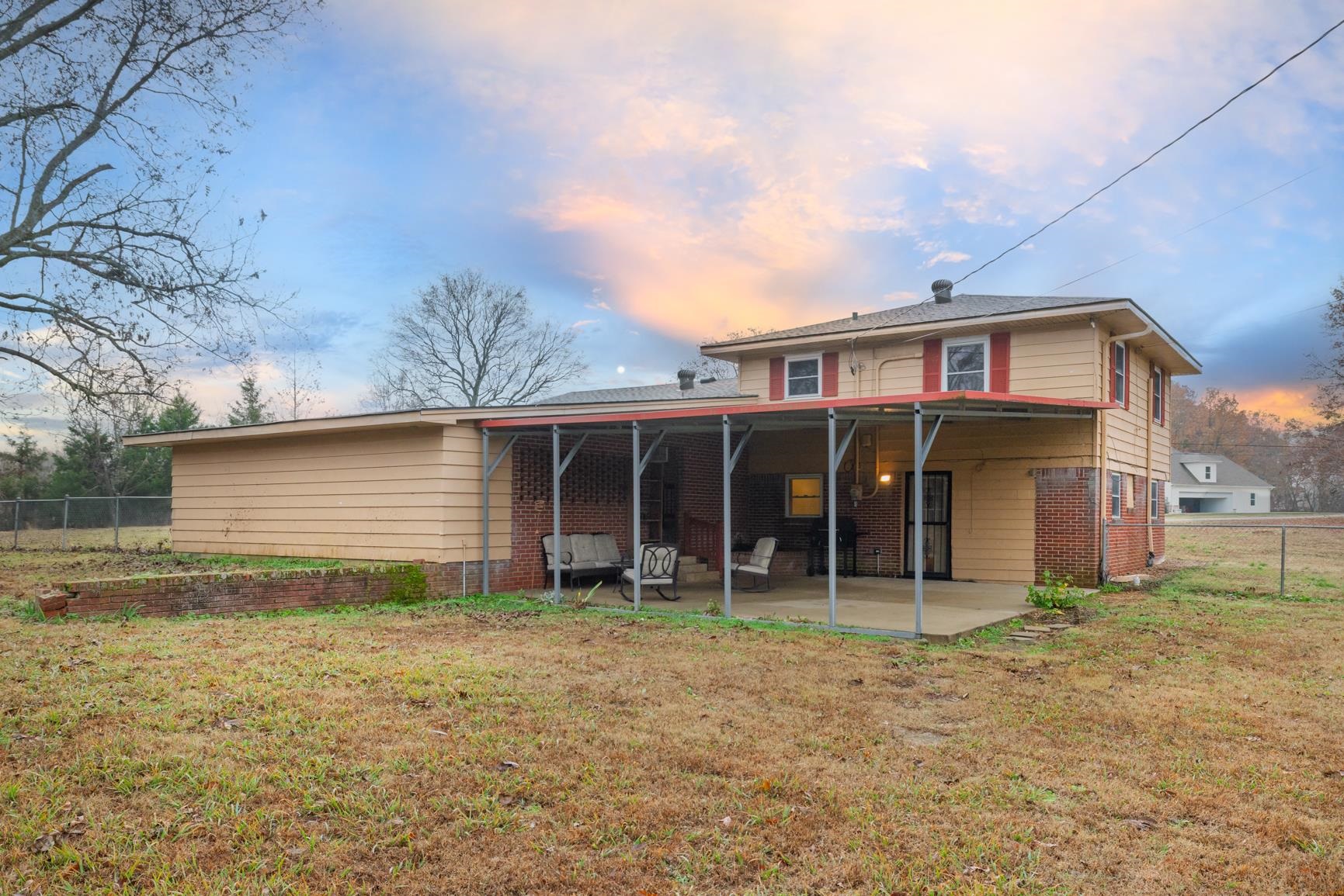 5466 Highway 59 Covington, TN 38019 - Photo 36 of 36 Back of house at dusk featuring a patio area and brick siding