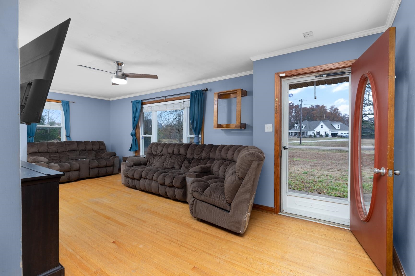 5466 Highway 59 Covington, TN 38019 - Photo 6 of 36 Living area featuring ornamental molding, light wood-type flooring, and a ceiling fan