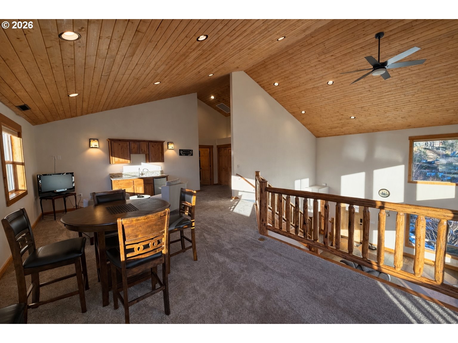 125 Melgard Court Detroit, OR 97342 - Photo 19 of 25 a open kitchen with stainless steel appliances kitchen island granite countertop a refrigerator a stove a dining table and chairs with wooden floor