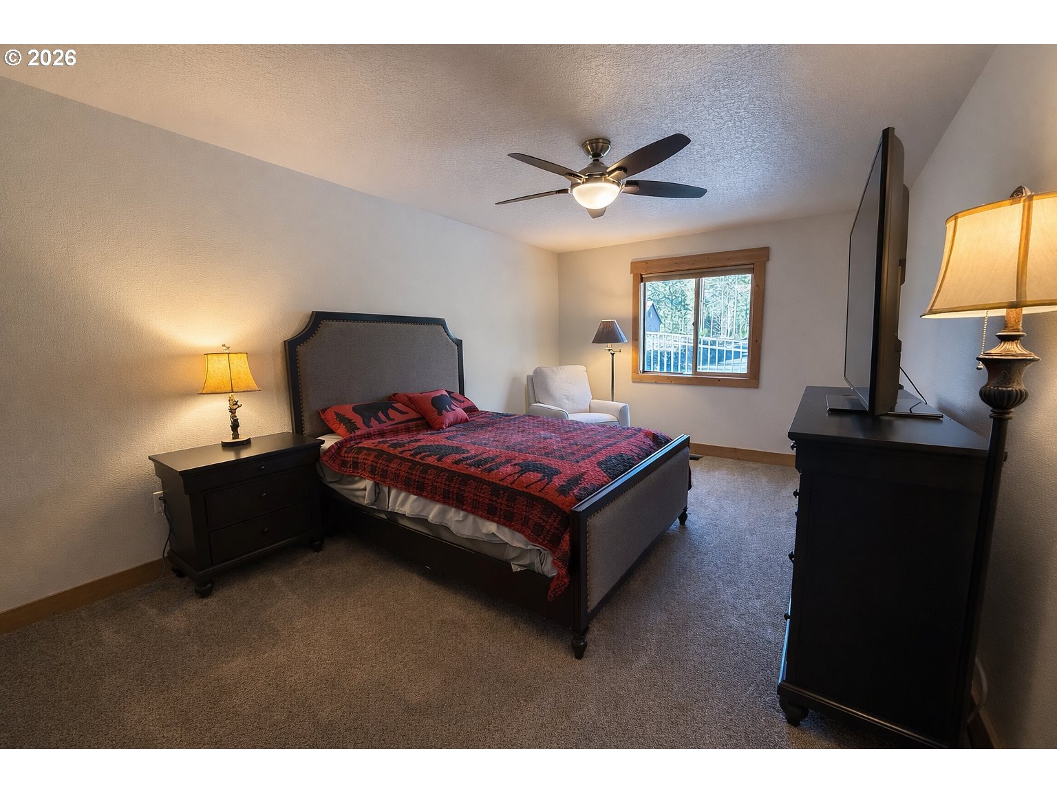 125 Melgard Court Detroit, OR 97342 - Photo 21 of 25 a spacious bedroom with a bed and a flat screen tv