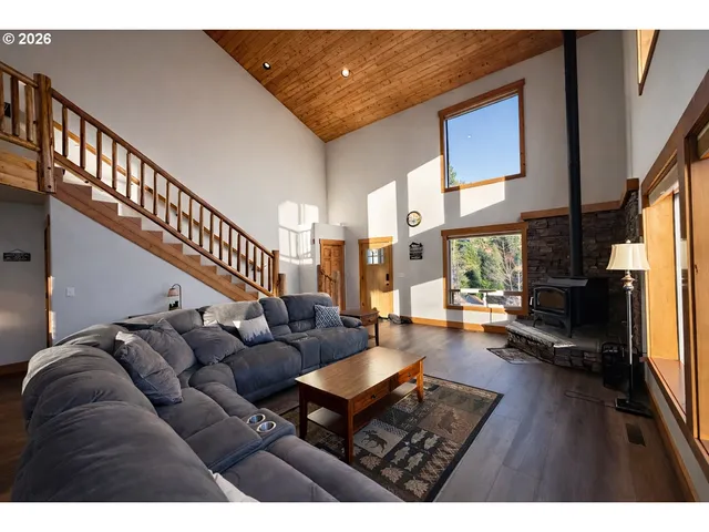 a living room with furniture and a floor to ceiling window