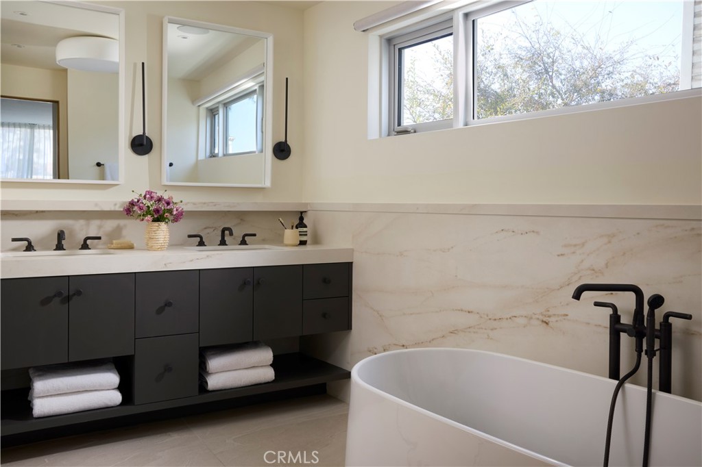 316 24th Street Hermosa Beach, CA 90254 - Photo 13 of 19 a bathroom with a tub sink and mirror
