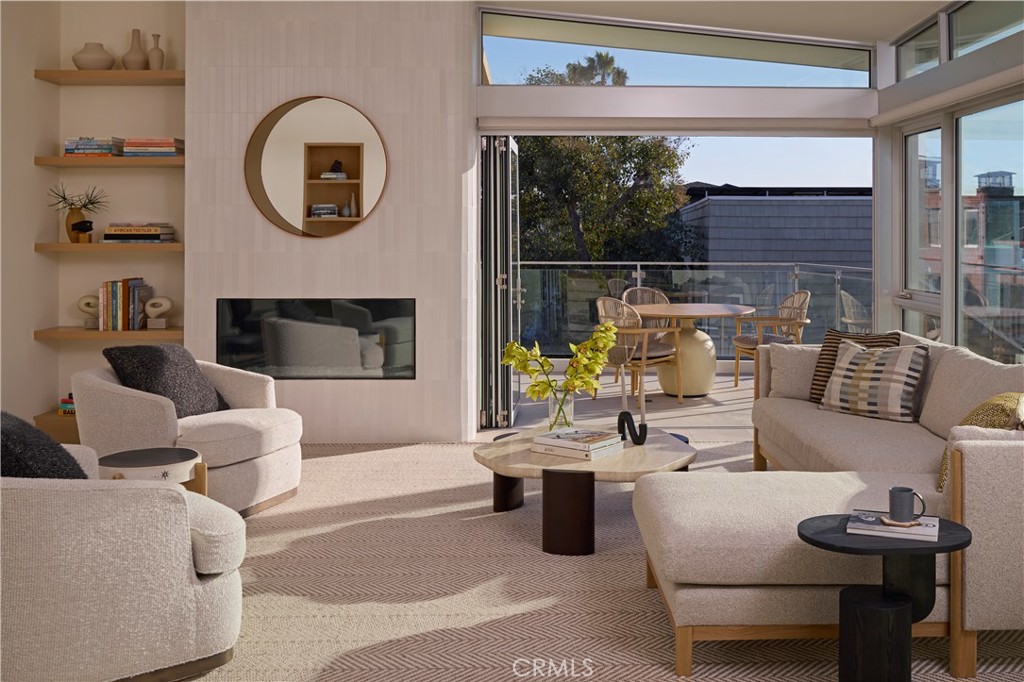 316 24th Street Hermosa Beach, CA 90254 - Photo 7 of 19 a living room with furniture a fireplace and a floor to ceiling window