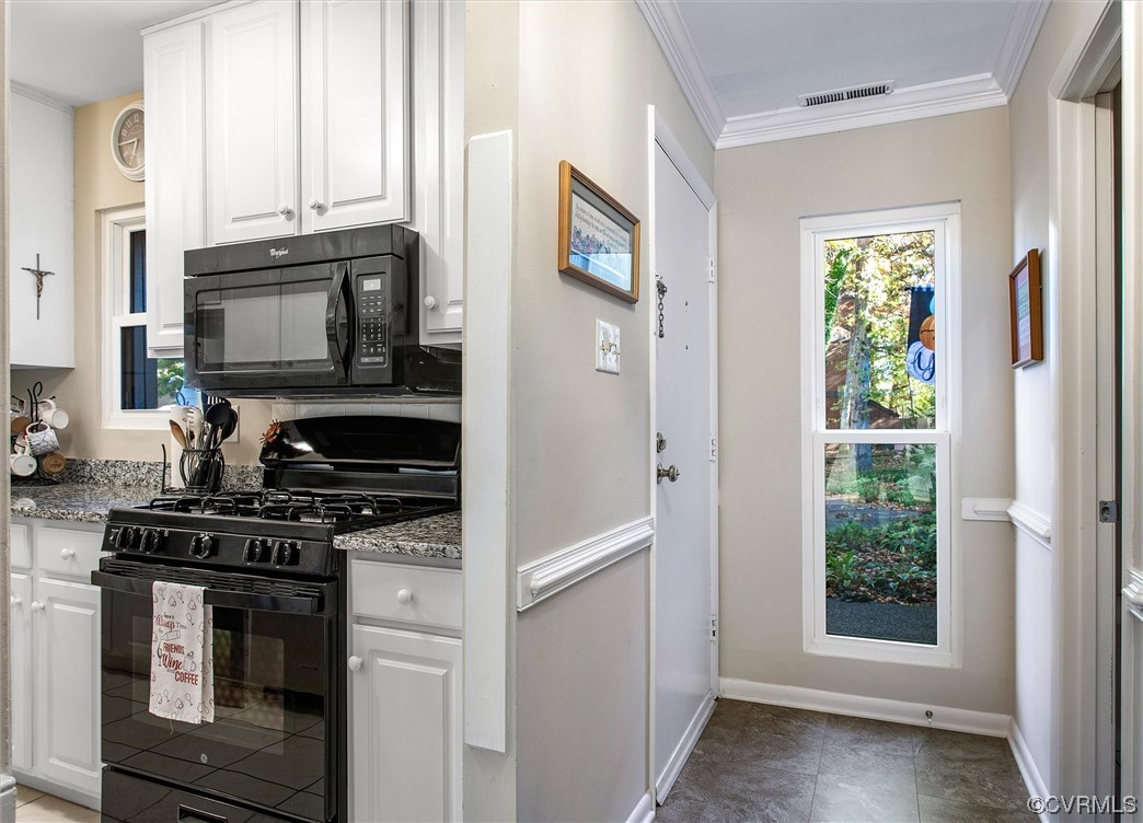 11629 East Briar Patch Drive Midlothian, VA 23113 - Photo 4 of 27 a kitchen with stainless steel appliances granite countertop a stove and a microwave