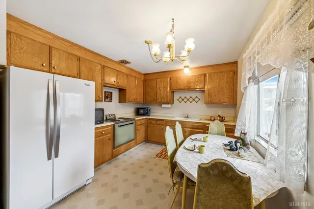 a kitchen with a refrigerator a stove a sink and a refrigerator