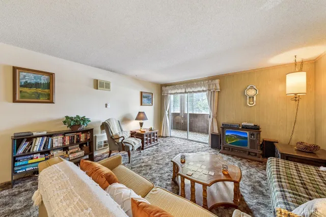 a living room with furniture stairs and a window