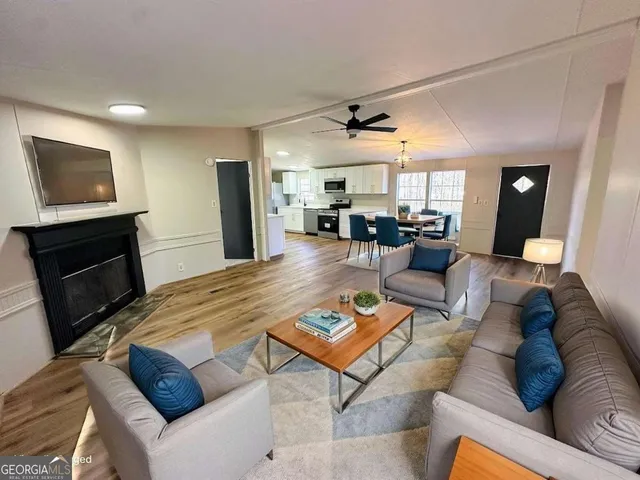 a living room with furniture and a flat screen tv