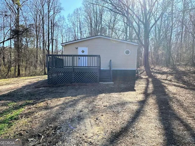 a view of a house with a yard covered with snow in the background