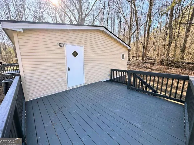a view of a house with wooden deck