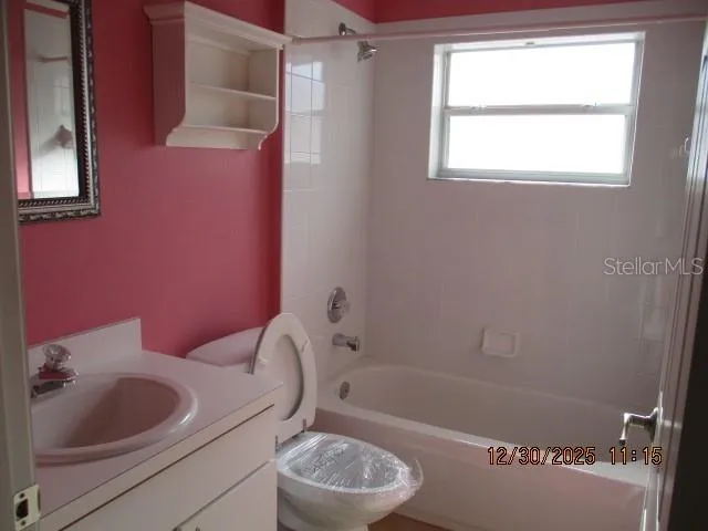 a bath room with a toilet sink and bath tub