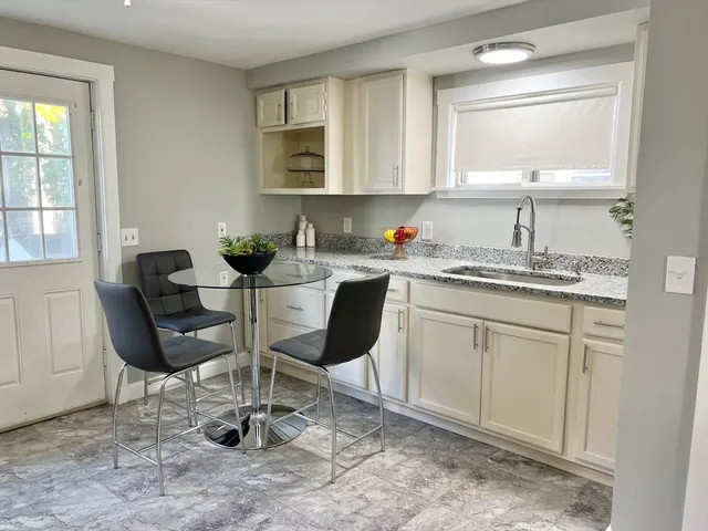a kitchen with a sink cabinets and dining table