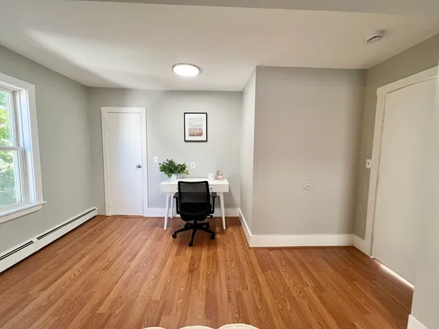 a view of room with window wooden floor and flat screen tv