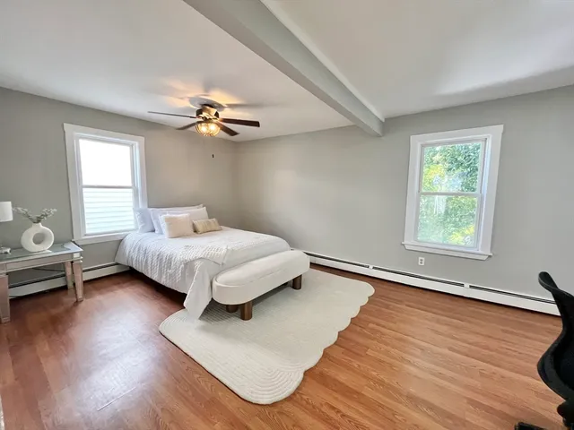 a bedroom with a bed couch and a window