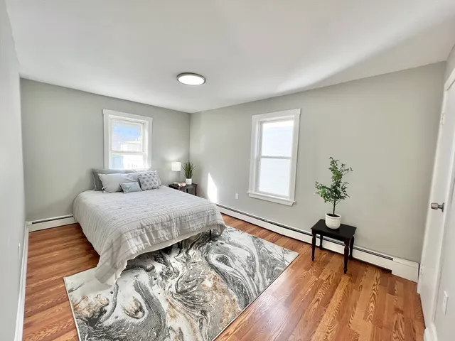a spacious bedroom with a bed and a window