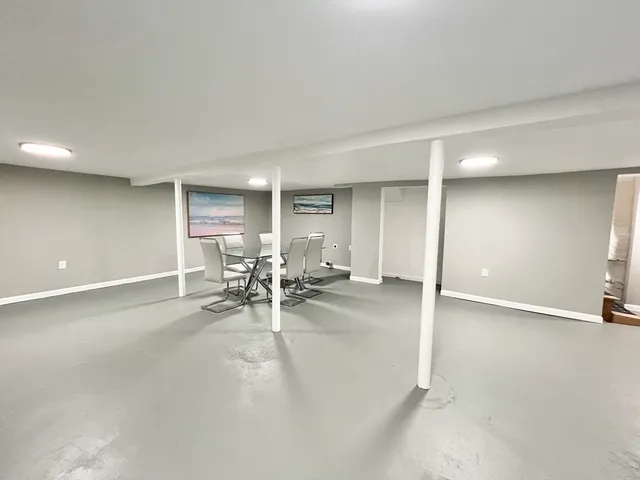 an empty room with furniture and a window