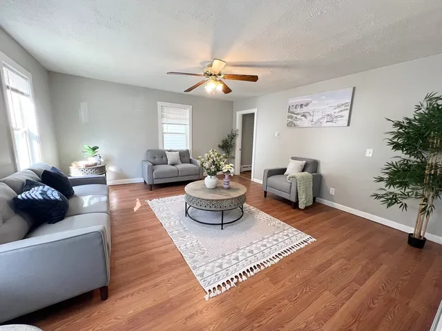 a living room with furniture and a chandelier