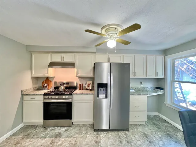 a kitchen with stainless steel appliances a stove a refrigerator and a sink