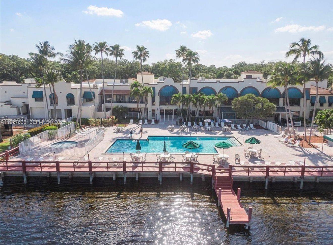 9431 Live Oak Place, Unit 205 Davie, FL 33324 - Photo 11 of 13 a view of swimming pool with outdoor seating and lake view