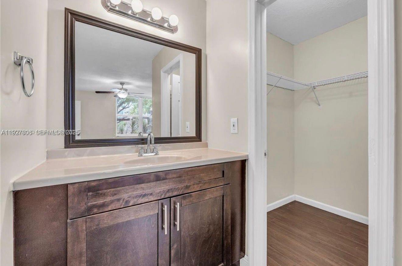 9431 Live Oak Place, Unit 205 Davie, FL 33324 - Photo 6 of 13 a bathroom with a granite countertop sink and a mirror