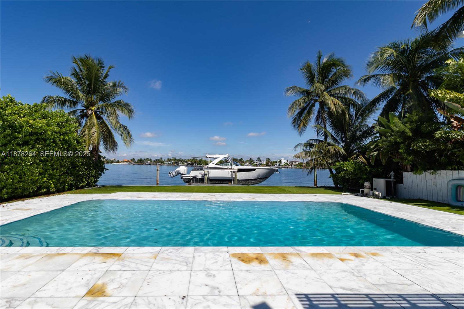1215 North Biscayne Point Road Miami Beach, FL 33141 - Photo 2 of 54 a view of a swimming pool and a yard