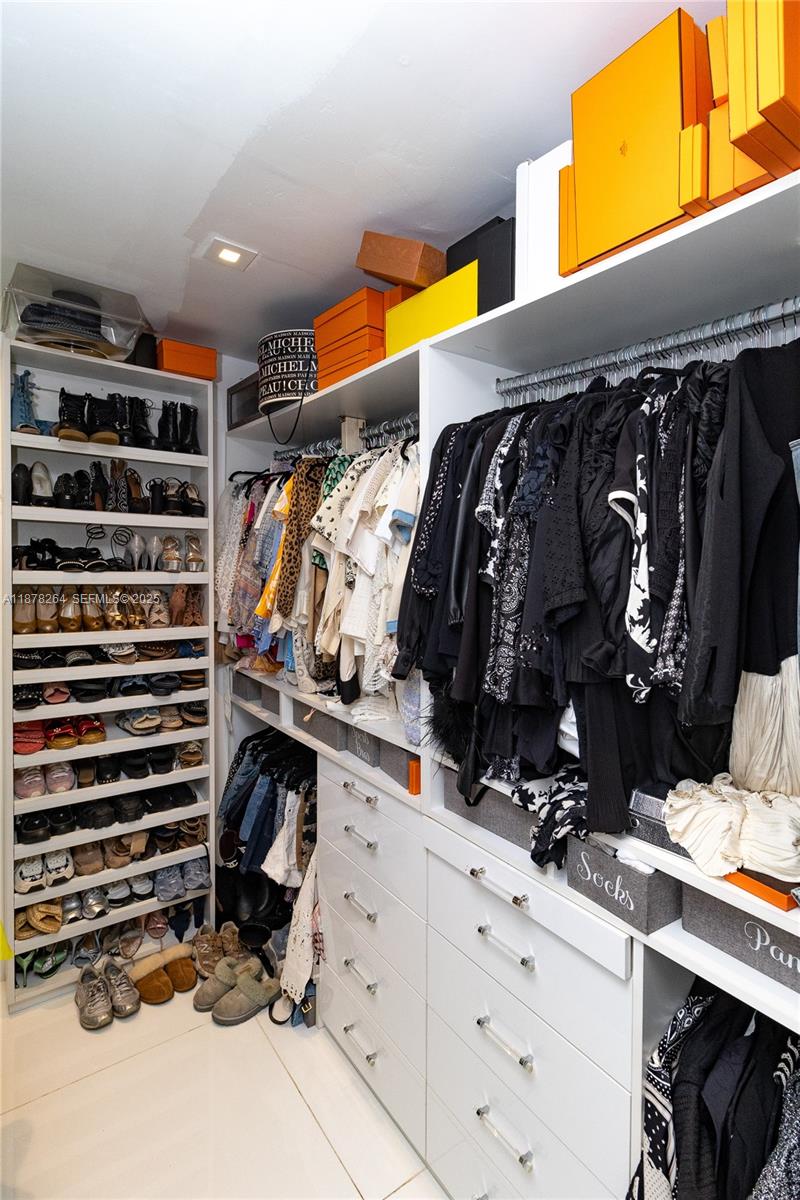 1215 North Biscayne Point Road Miami Beach, FL 33141 - Photo 26 of 54 a view of walk in closet with clothes and shoes