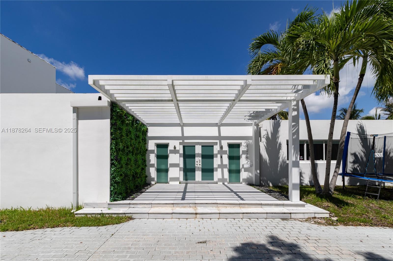 1215 North Biscayne Point Road Miami Beach, FL 33141 - Photo 3 of 54 a view of a patio with a table and chairs under an umbrella