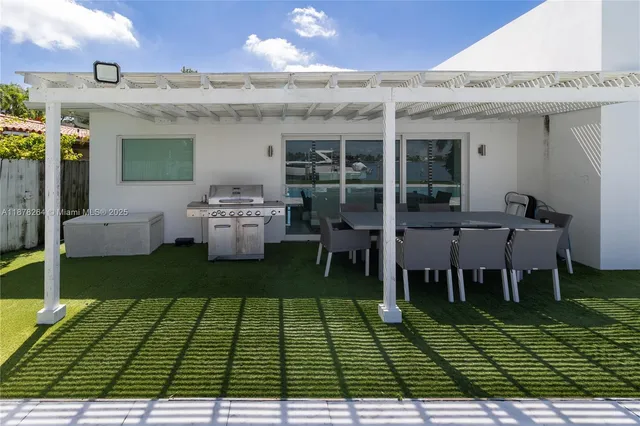 a view of a house with backyard and sitting area