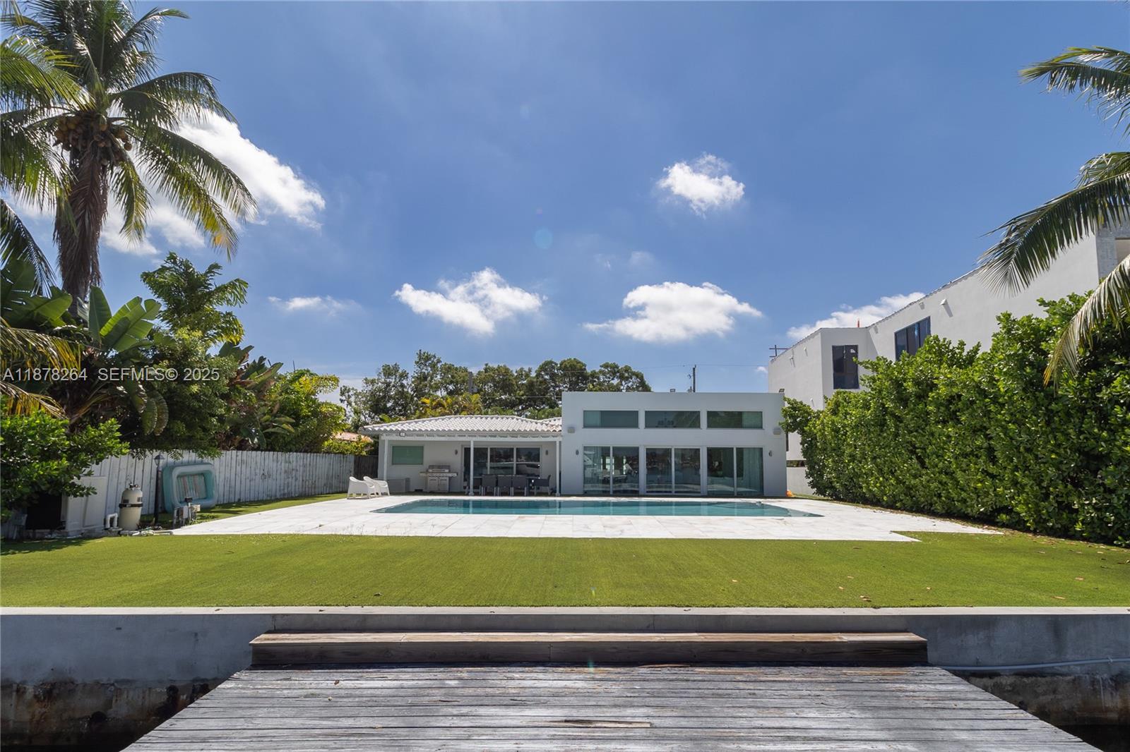 1215 North Biscayne Point Road Miami Beach, FL 33141 - Photo 46 of 54 a front view of a house with a yard and potted plants