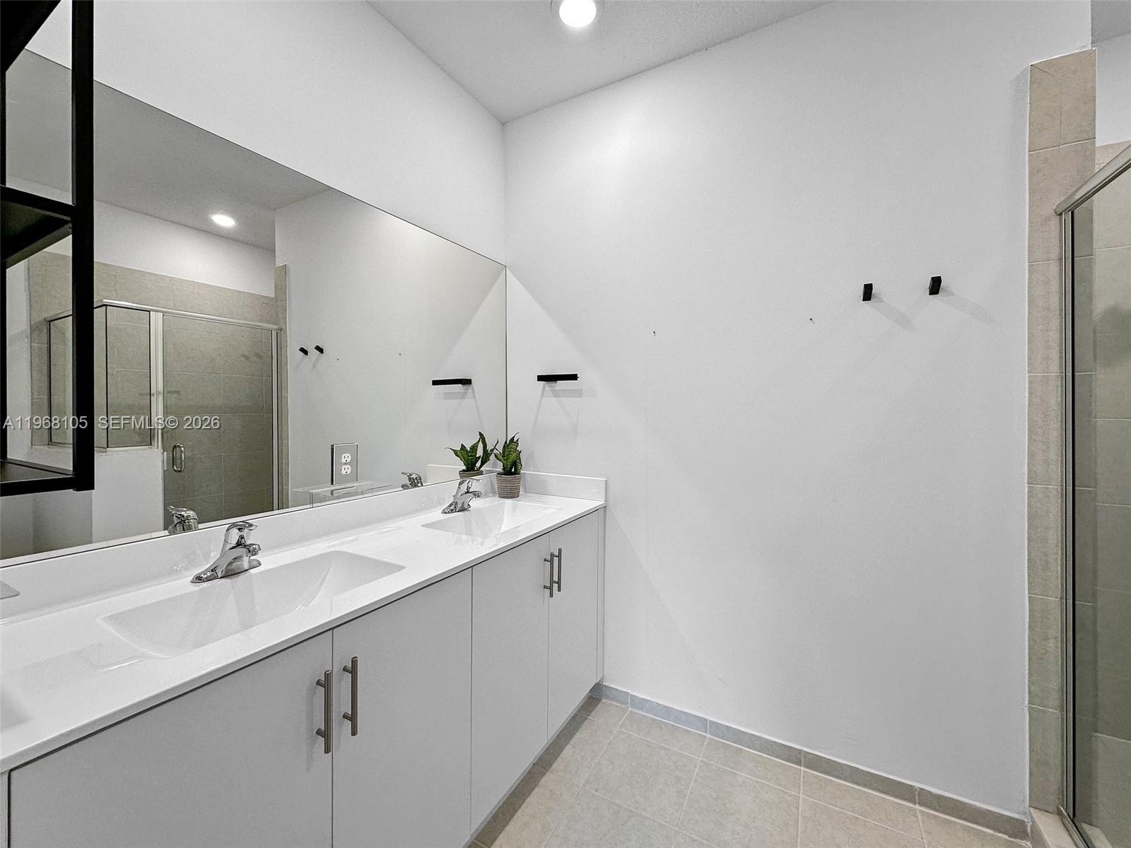 13402 Southwest 286th Street, Unit 13402 Homestead, FL 33033 - Photo 17 of 43 a bathroom with a sink and a mirror