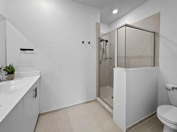 a bathroom with a shower and a toilet