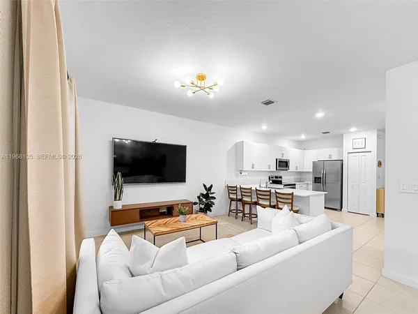 a living room with furniture and a flat screen tv