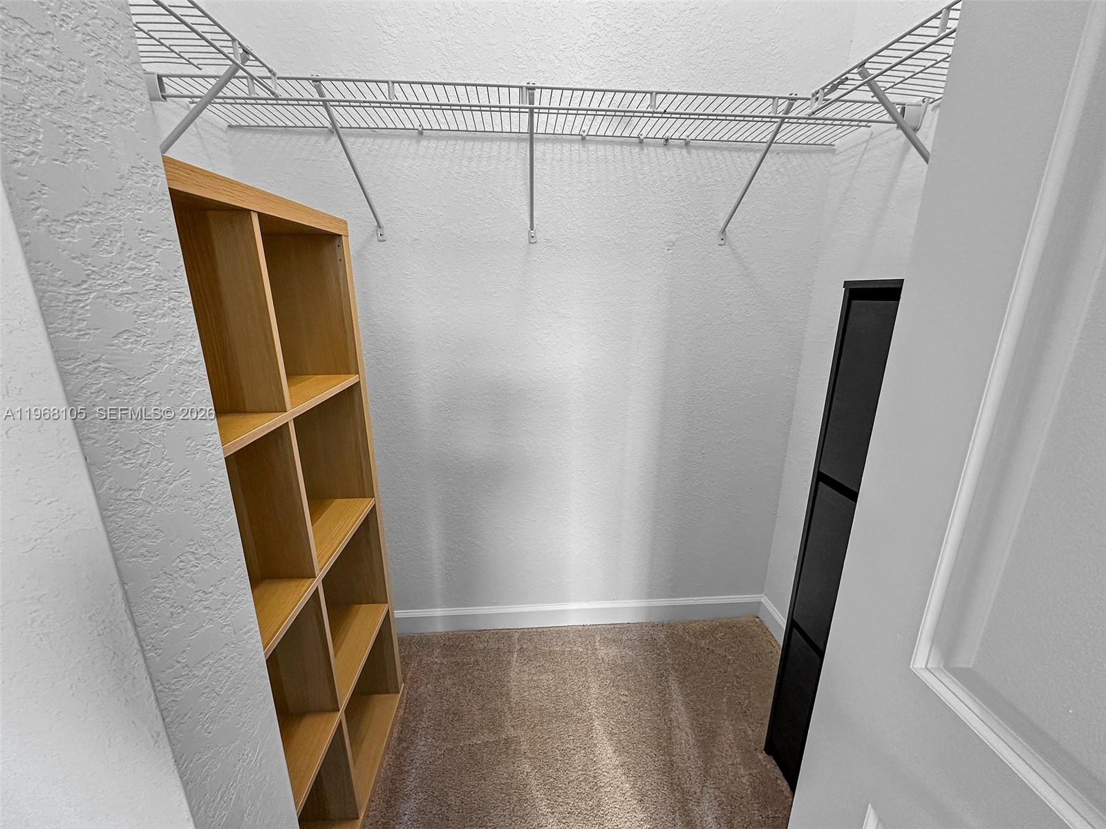 13402 Southwest 286th Street, Unit 13402 Homestead, FL 33033 - Photo 22 of 43 a view of walk in closet with empty space and wooden floor