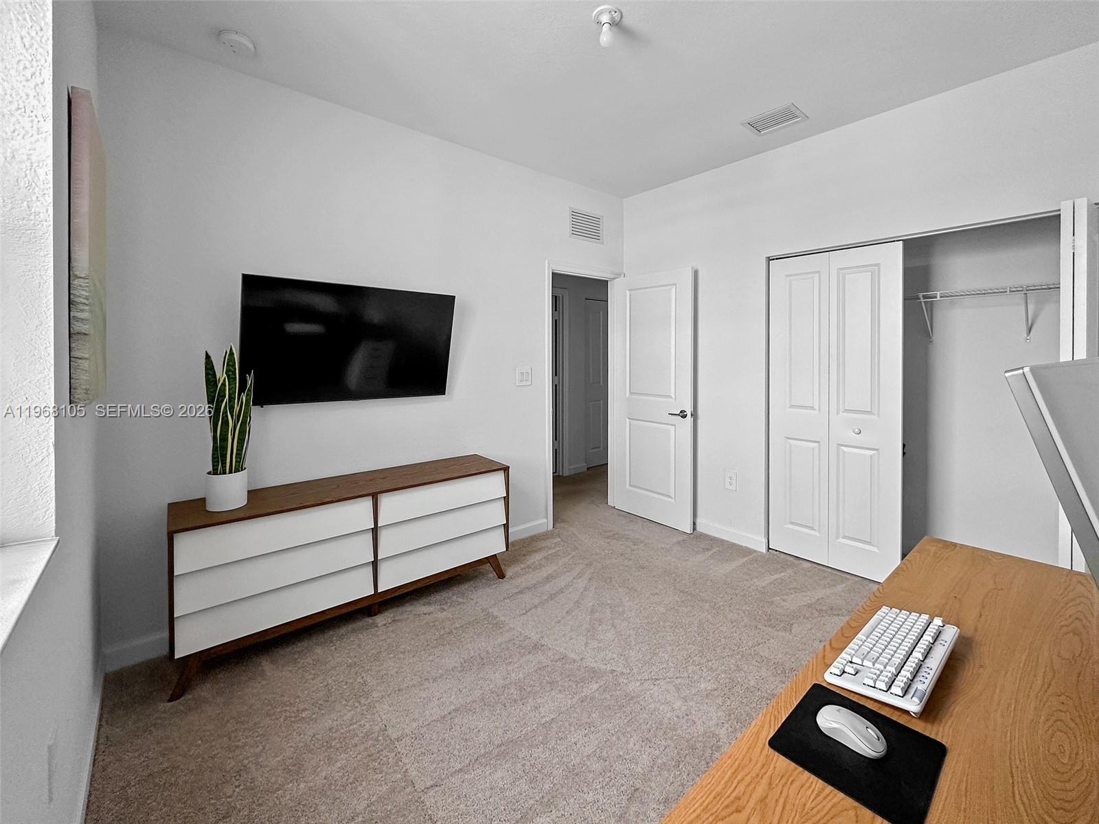 13402 Southwest 286th Street, Unit 13402 Homestead, FL 33033 - Photo 26 of 43 a living room with furniture and a flat screen tv