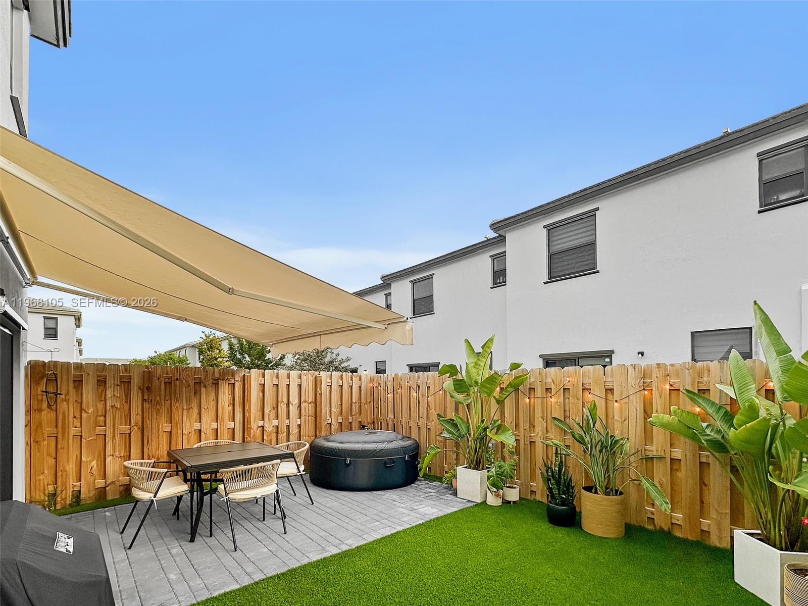 13402 Southwest 286th Street, Unit 13402 Homestead, FL 33033 - Photo 29 of 43 a backyard of a house with table and chairs
