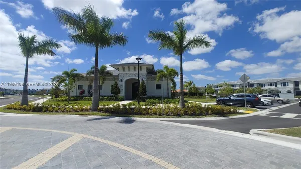 a front view of a house with lots of green space